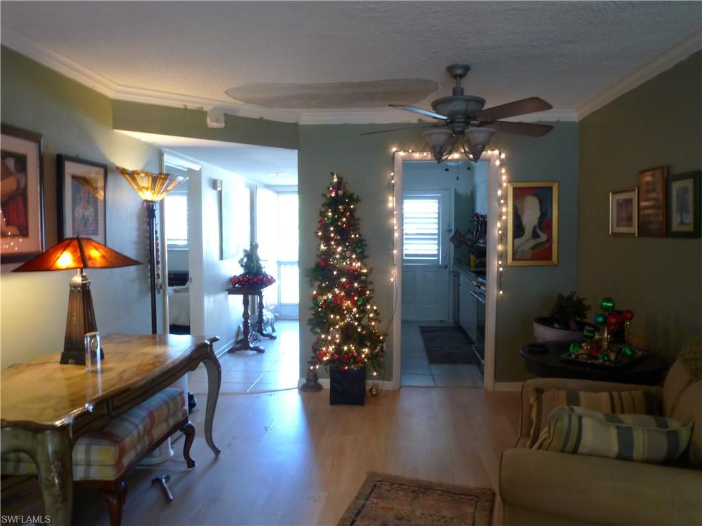 72 7th Street South, Unit 203 Naples, FL 34102 - Photo 4 of 23 a living room with furniture and wooden floor