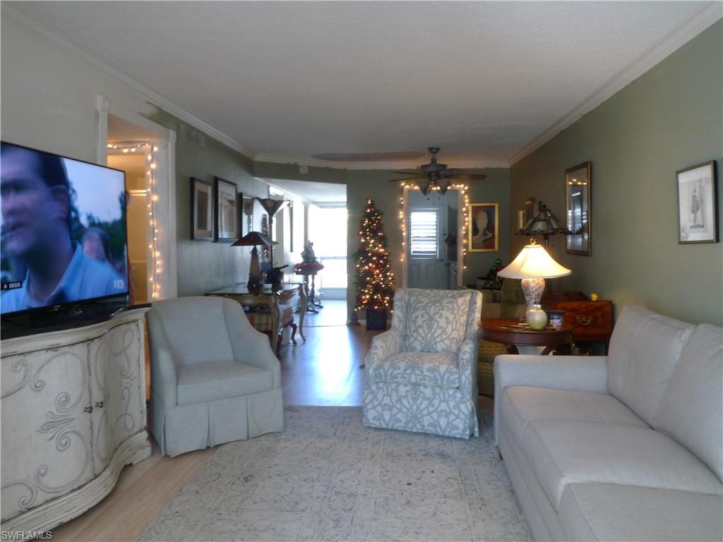 72 7th Street South, Unit 203 Naples, FL 34102 - Photo 5 of 23 a living room with furniture and a lamp