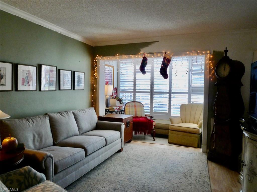 72 7th Street South, Unit 203 Naples, FL 34102 - Photo 6 of 23 a living room with furniture and a window