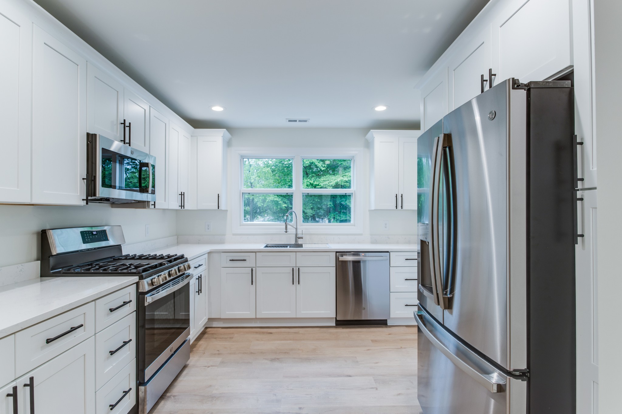 1008 South Spring Street Manchester, TN 37355 - Photo 16 of 60 Stunning kitchen with new cabinets, quartz countertops, recessed lighting and LVP flooring.