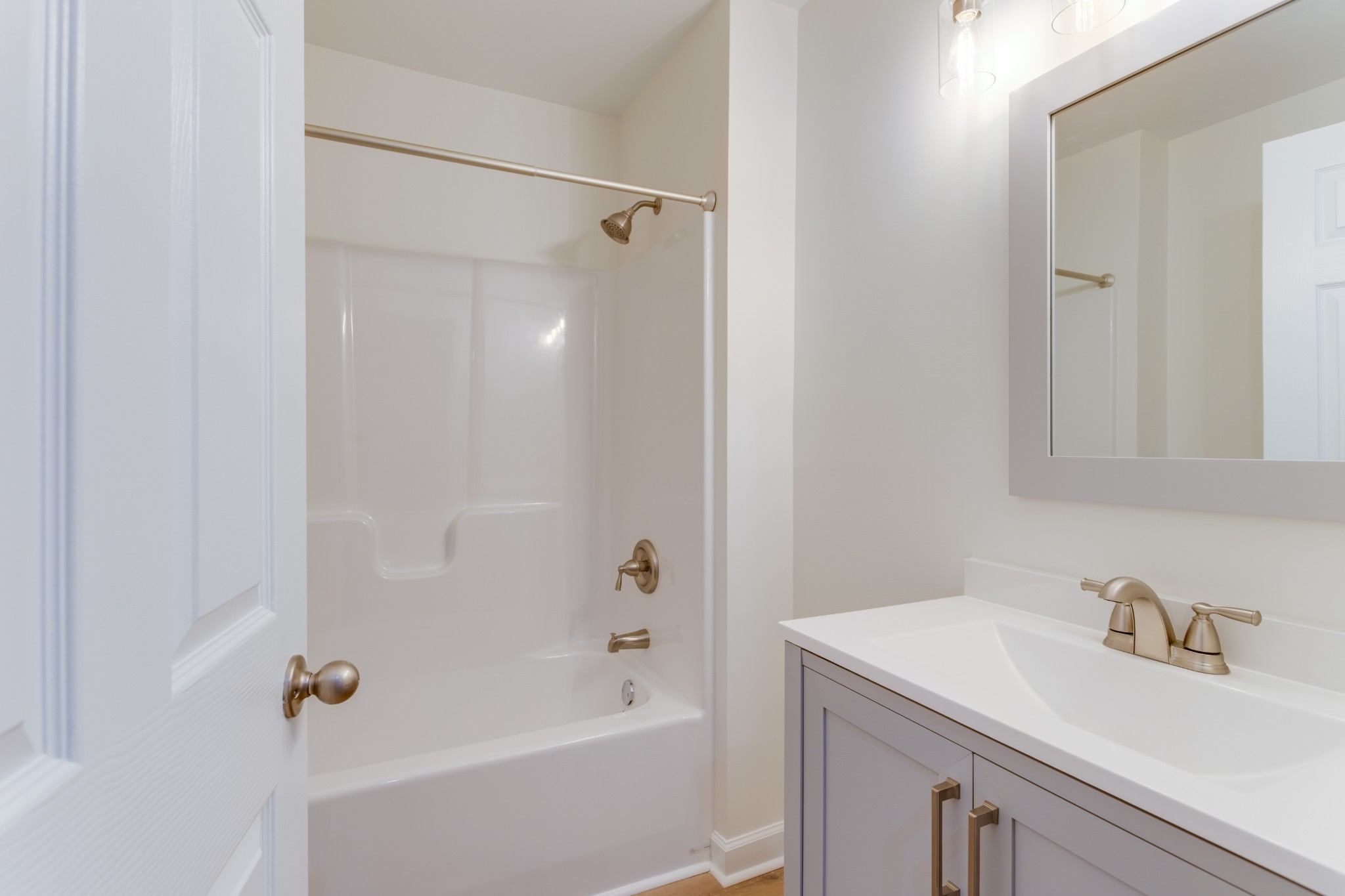 1008 South Spring Street Manchester, TN 37355 - Photo 33 of 60 Primary bathroom with new single vanity, new fixtures, new shower/tub combo, new paint and new LVP flooring. Convenient to both bedrooms.