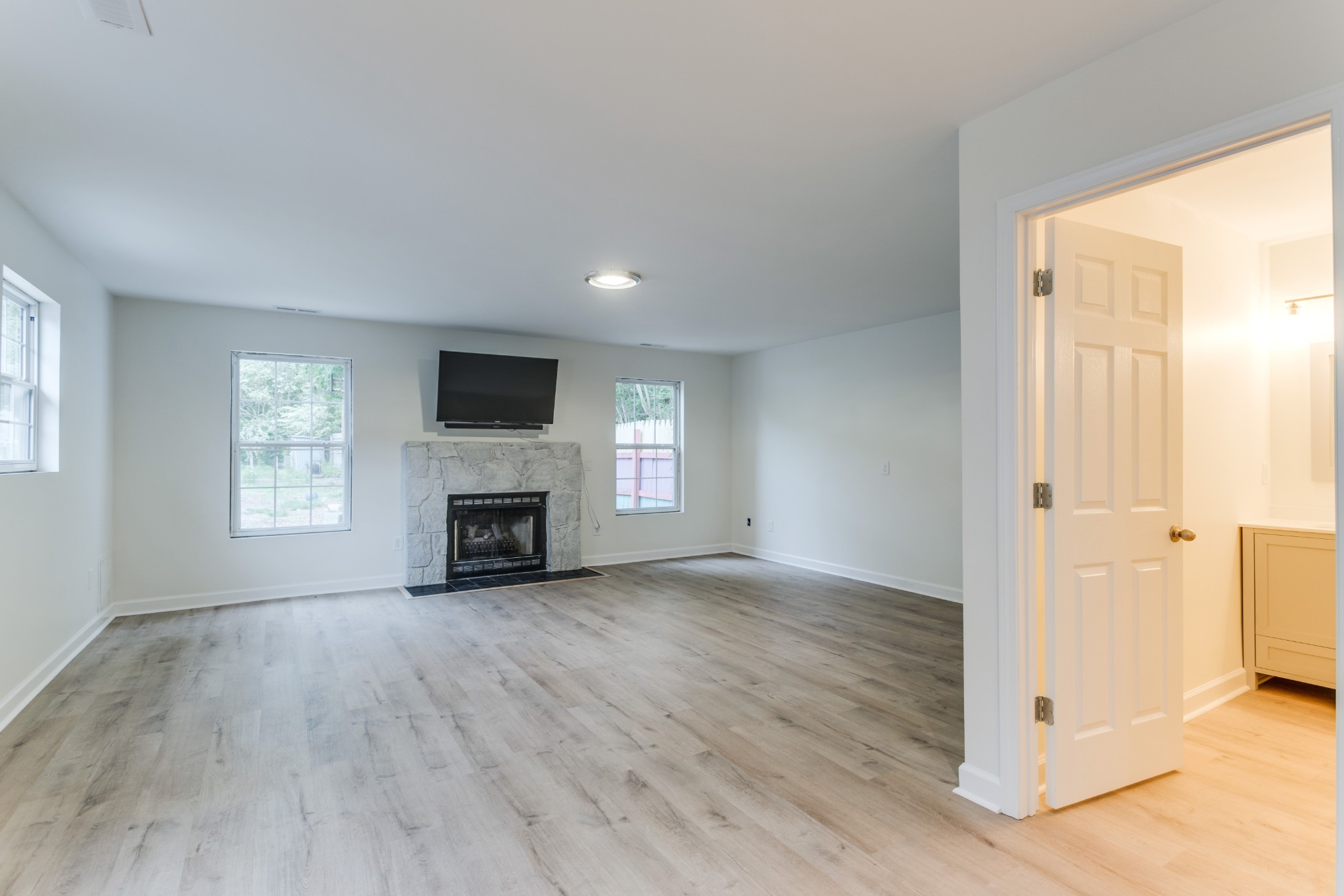 1008 South Spring Street Manchester, TN 37355 - Photo 36 of 60 Large den with new LVP flooring, new gas fireplace and hearth.