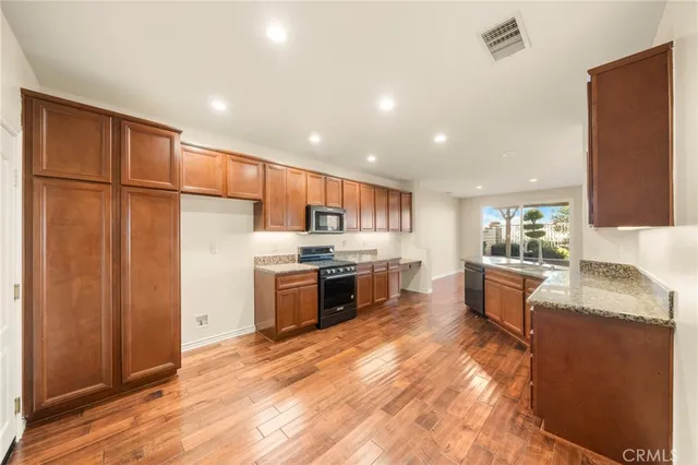 a kitchen with stainless steel appliances granite countertop a stove and a sink