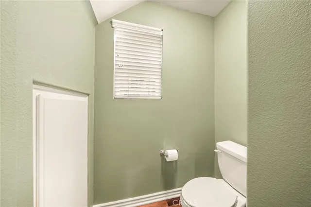 a bed room with a bed a couch and a window