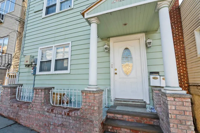 a front view of a house with many windows