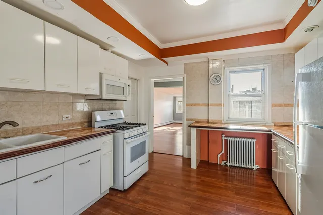 a kitchen with stainless steel appliances granite countertop wooden cabinets and a stove top oven