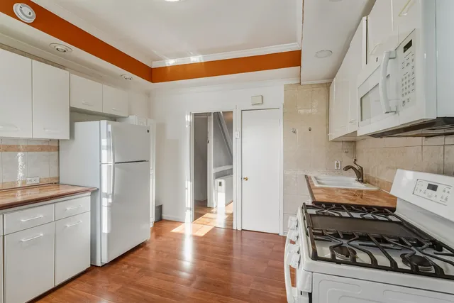 a kitchen with a stove and a refrigerator