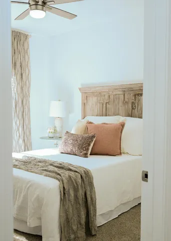 a bed sitting in a bedroom next to a window