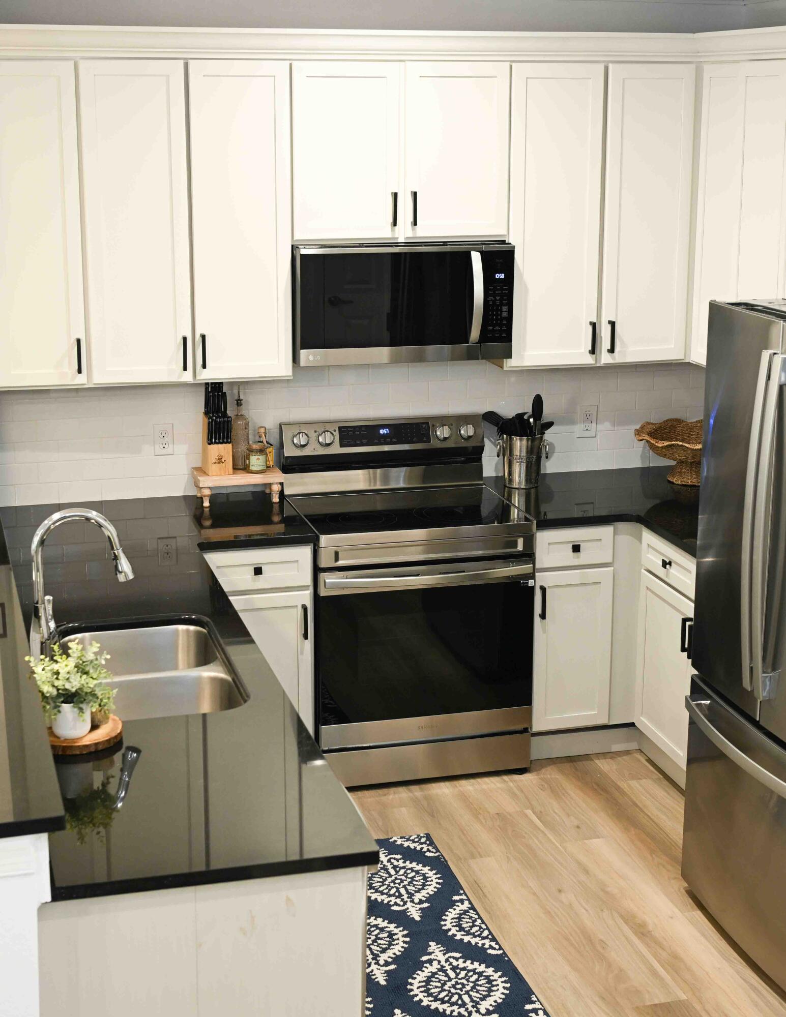 90 Southaven Circle Santa Rosa Beach, FL 32459 - Photo 5 of 29 a kitchen with stainless steel appliances a stove a sink and a microwave