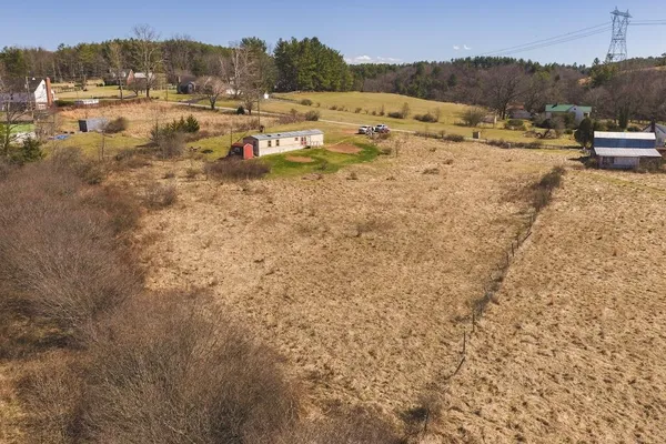 a view of a dry yard with mountain view