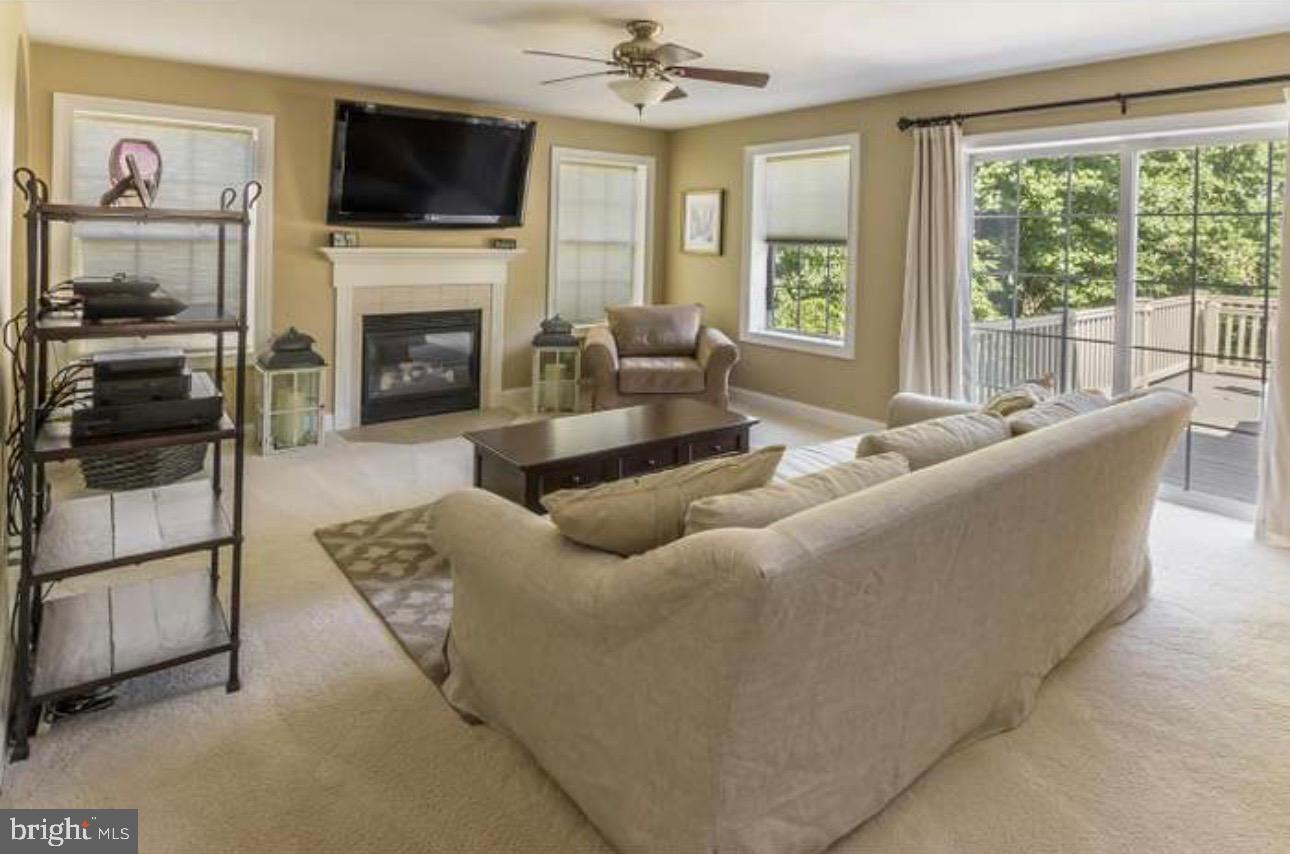 29 South Elmwood Road Marlton, NJ 08053 - Photo 5 of 24 a living room with furniture a flat screen tv and a fireplace