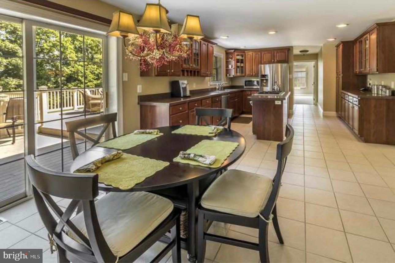 29 South Elmwood Road Marlton, NJ 08053 - Photo 8 of 24 a view of a dining room with furniture a chandelier and wooden floor