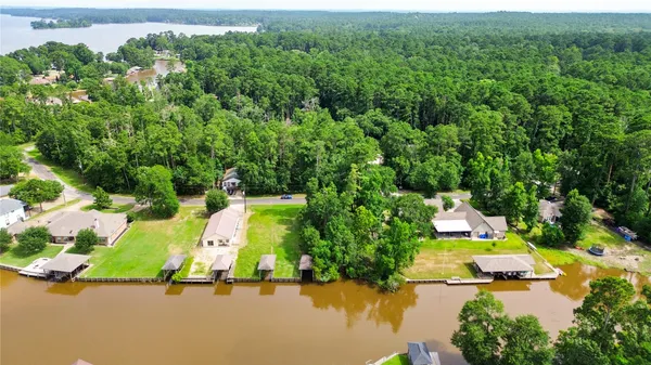 an aerial view of residential houses with outdoor space and swimming pool