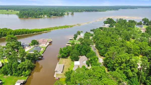 an aerial view of a houses with a lake view