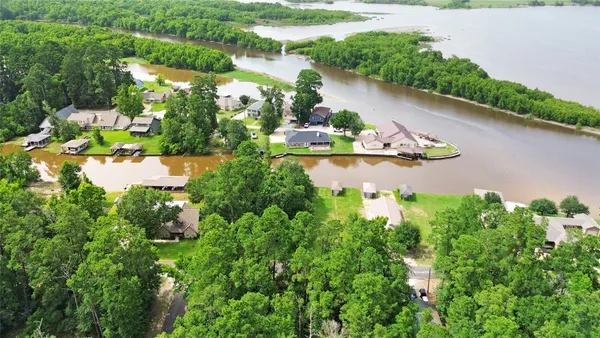 an aerial view of lake residential house with swimming pool and outdoor space
