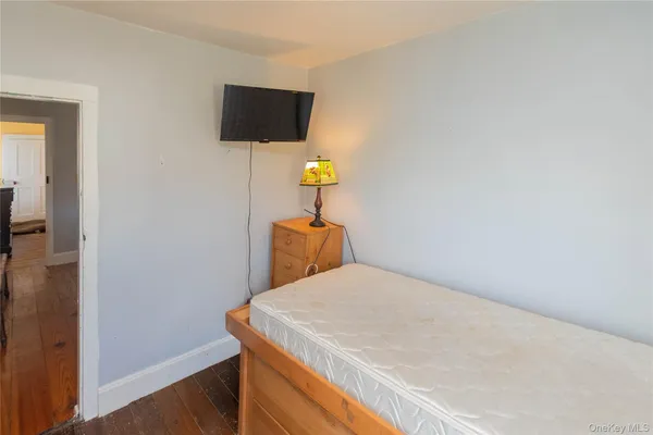 a bedroom with a bed and a television