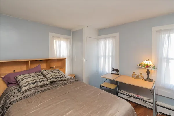 a bedroom with a bed and window