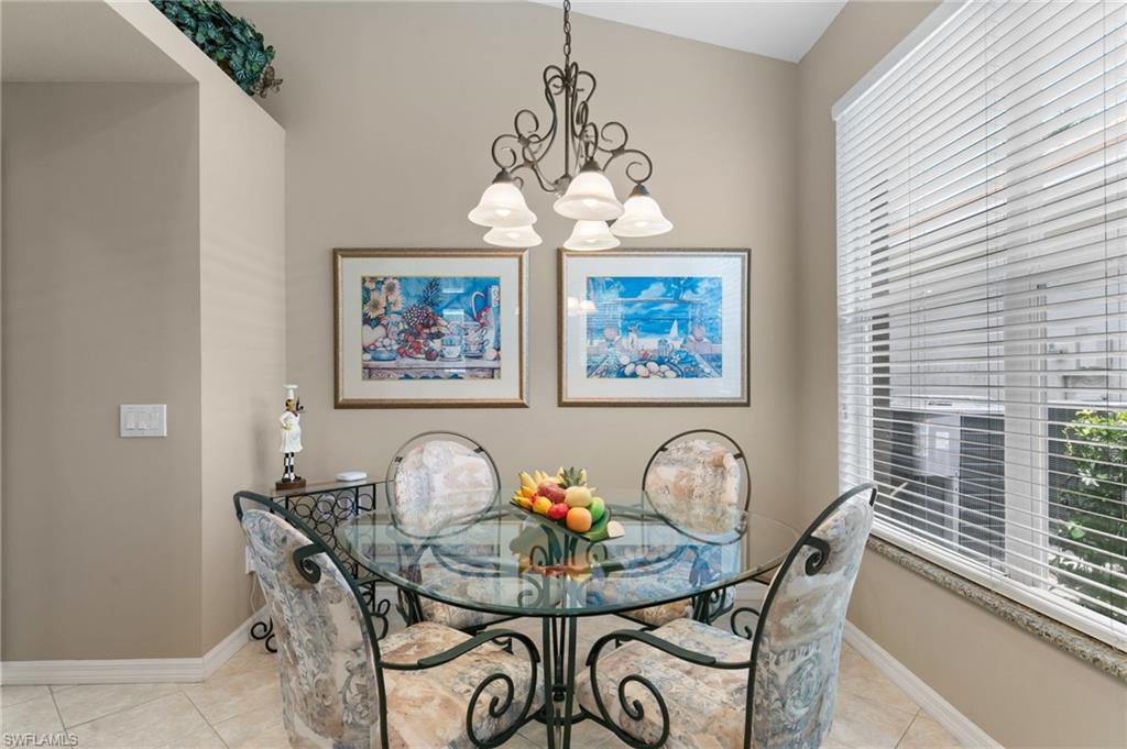 1717 Winding Oaks Way Naples, FL 34109 - Photo 16 of 35 Dining space featuring a chandelier and light tile floors