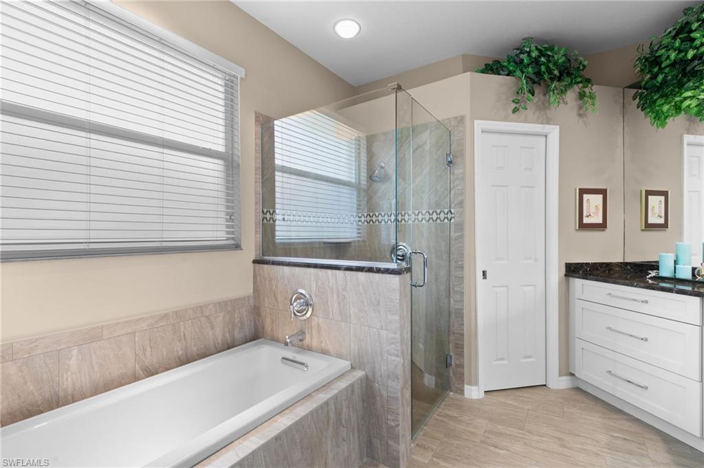1717 Winding Oaks Way Naples, FL 34109 - Photo 20 of 35 Bathroom with tile flooring, independent shower and bath, and vanity
