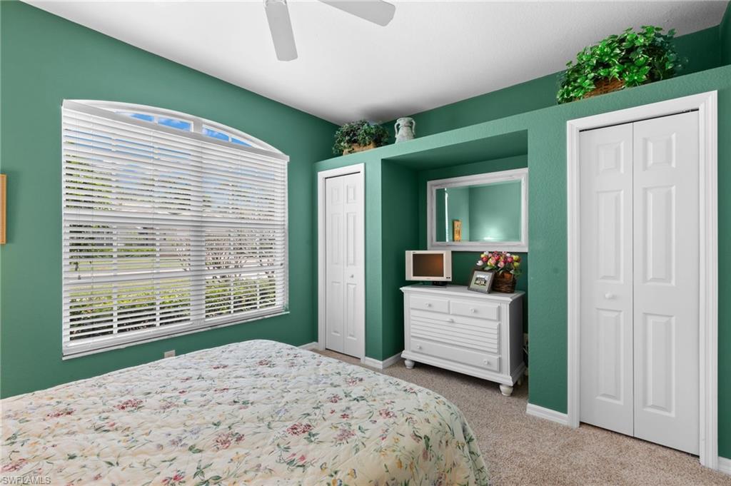 1717 Winding Oaks Way Naples, FL 34109 - Photo 21 of 35 Bedroom featuring multiple closets, ceiling fan, and carpet floors
