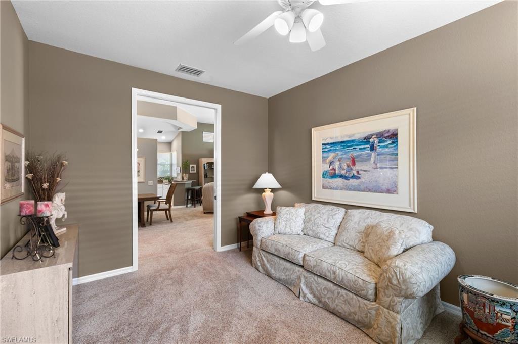 1717 Winding Oaks Way Naples, FL 34109 - Photo 25 of 35 Carpeted living room featuring ceiling fan