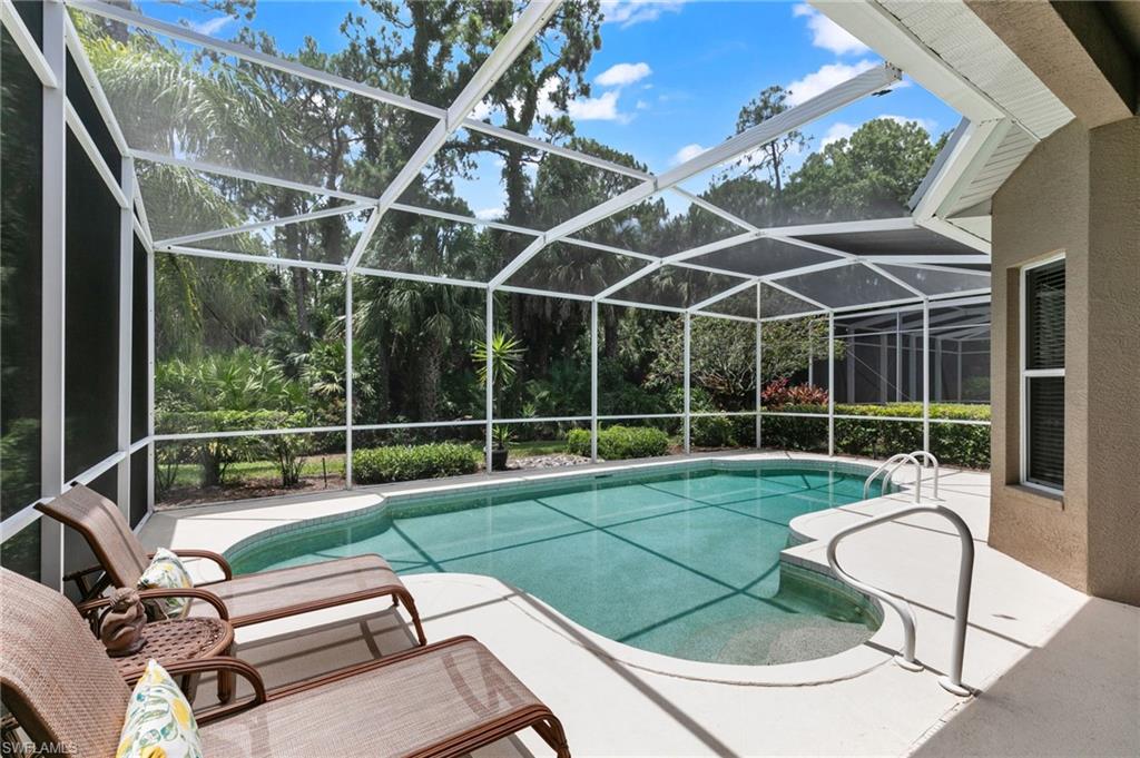 1717 Winding Oaks Way Naples, FL 34109 - Photo 28 of 35 View of swimming pool featuring a lanai and a patio