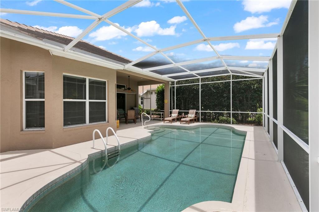 1717 Winding Oaks Way Naples, FL 34109 - Photo 29 of 35 View of pool featuring glass enclosure, a patio area, and ceiling fan