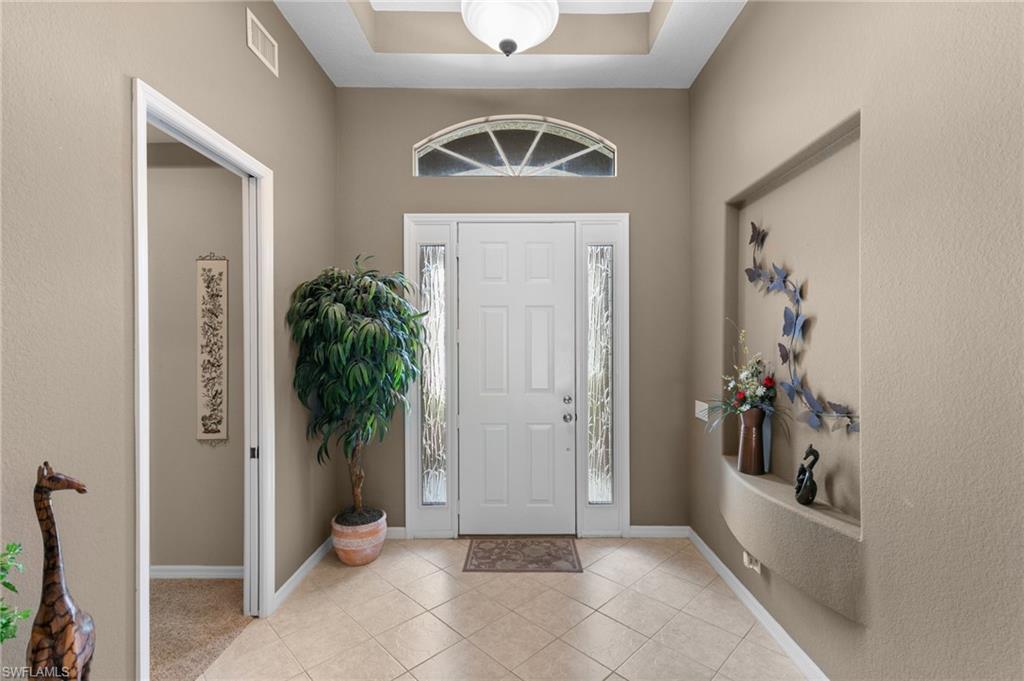 1717 Winding Oaks Way Naples, FL 34109 - Photo 4 of 35 Tiled entrance foyer featuring a tray ceiling