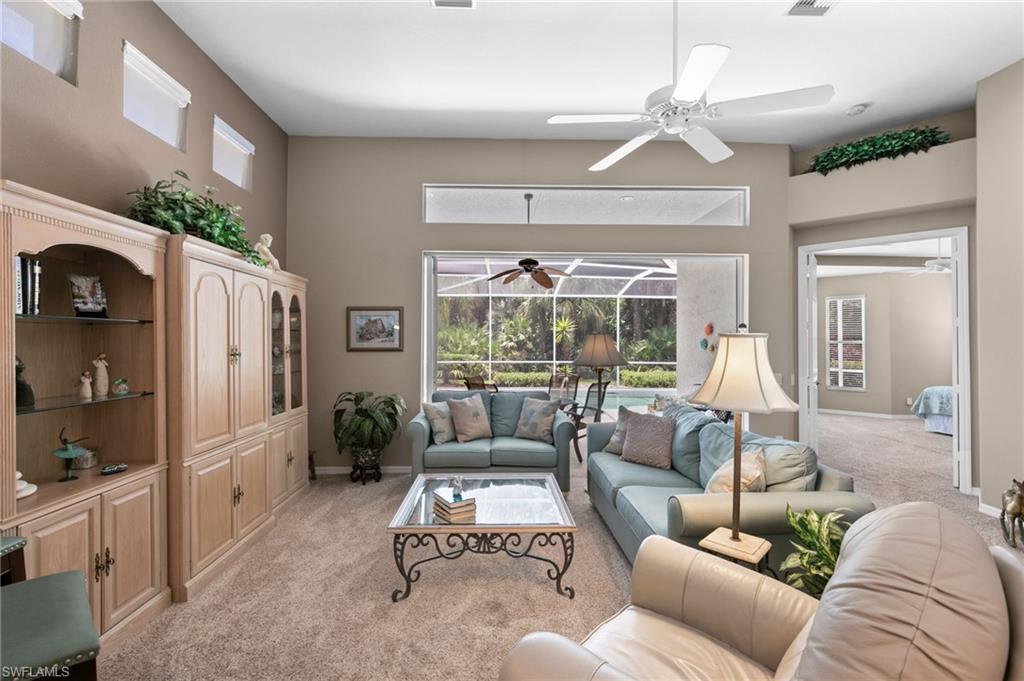 1717 Winding Oaks Way Naples, FL 34109 - Photo 10 of 35 Living room featuring ceiling fan and light colored carpet
