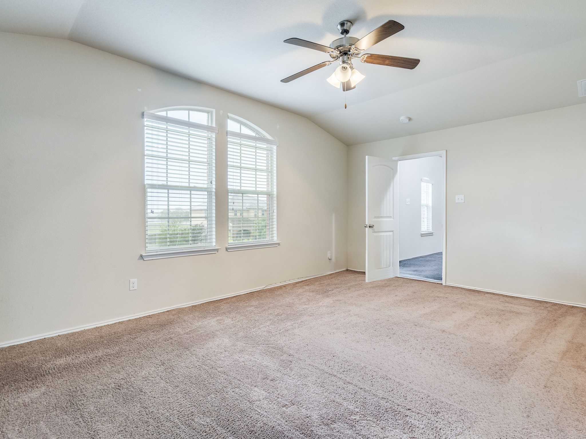 213 Ammonite Lane Jarrell, TX 76537 - Photo 19 of 34 an empty room with chandelier fan and windows