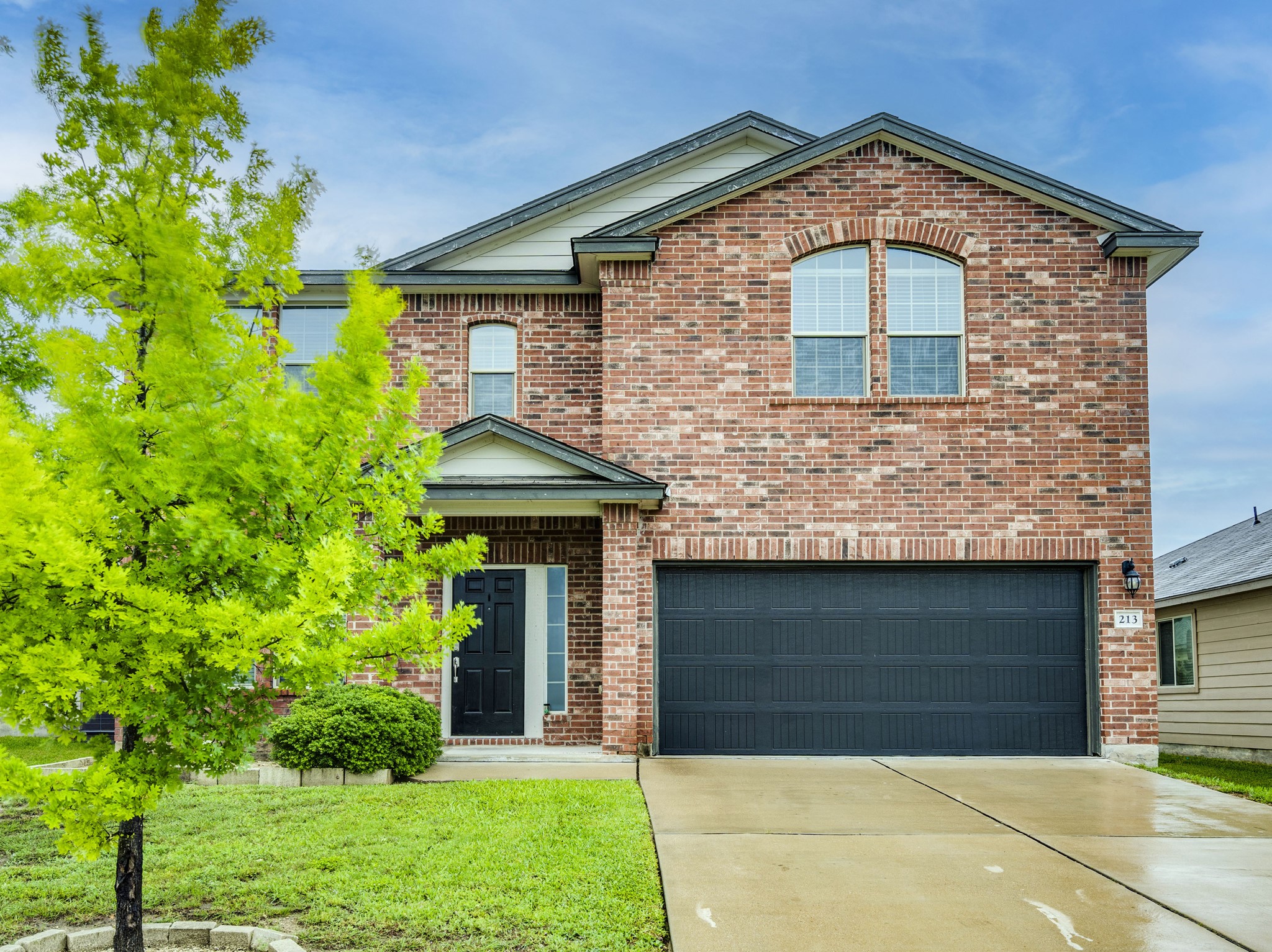 213 Ammonite Lane Jarrell, TX 76537 - Photo 2 of 34 a front view of a house with a yard