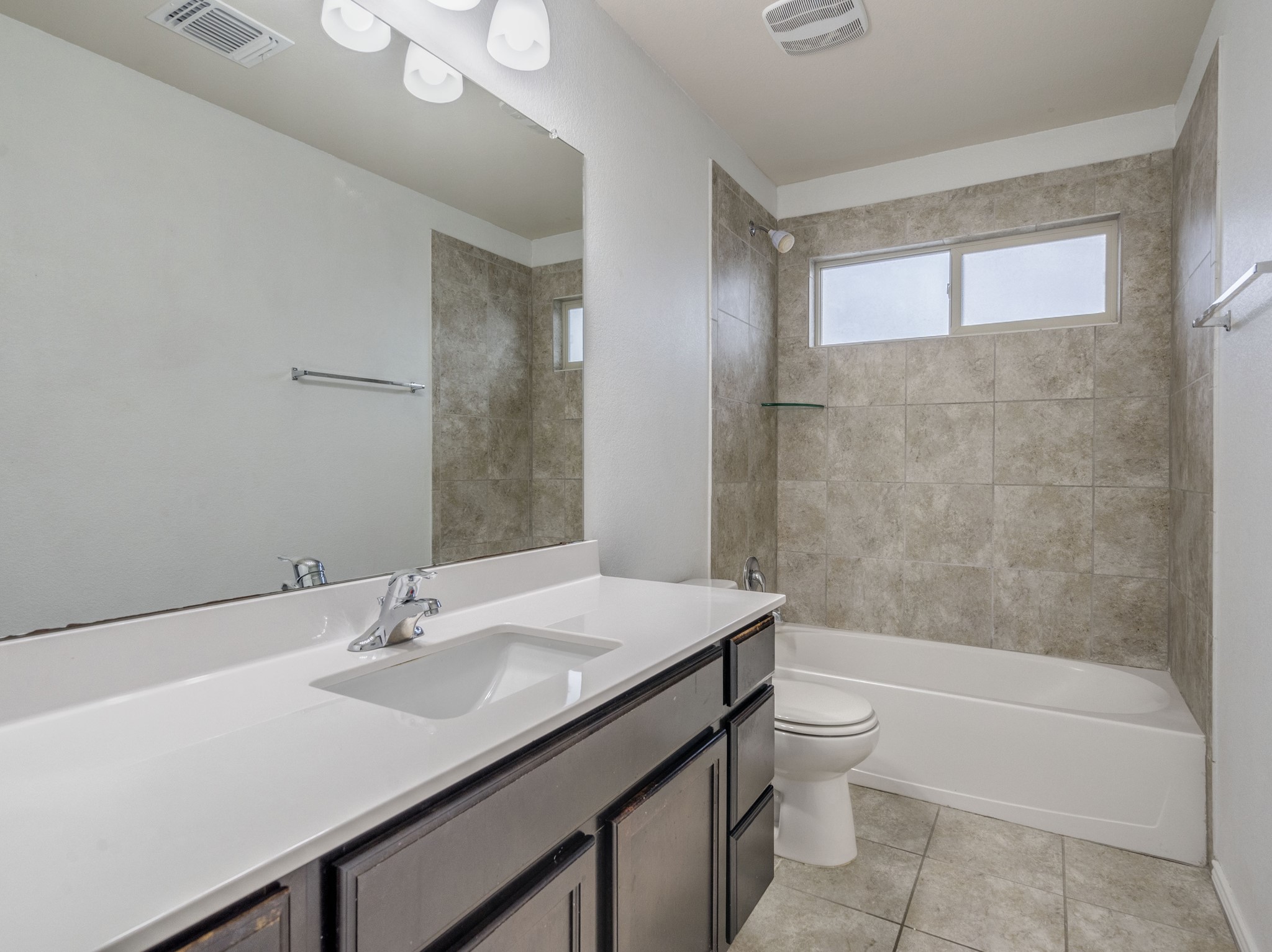 213 Ammonite Lane Jarrell, TX 76537 - Photo 28 of 34 a bathroom with a sink a toilet and shower