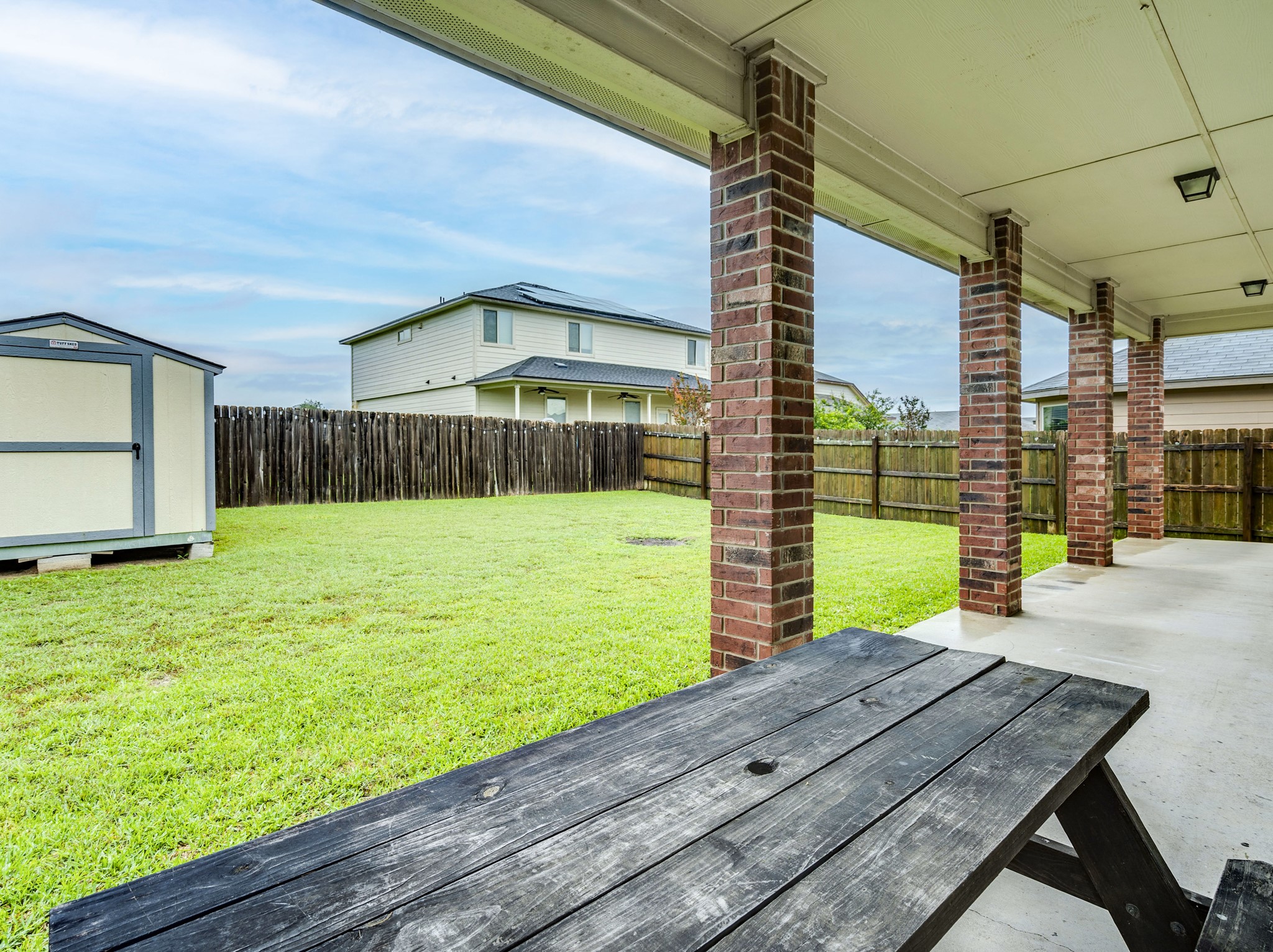 213 Ammonite Lane Jarrell, TX 76537 - Photo 30 of 34 a view of a backyard with a garden