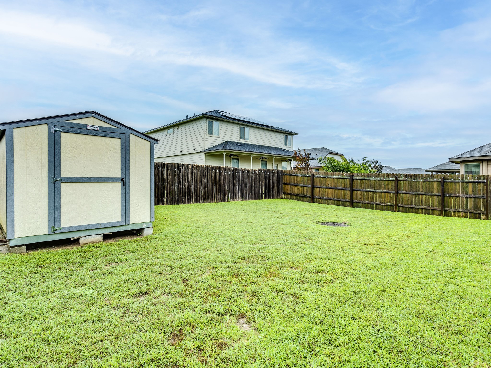213 Ammonite Lane Jarrell, TX 76537 - Photo 31 of 34 a view of a backyard with a garden and entertaining space