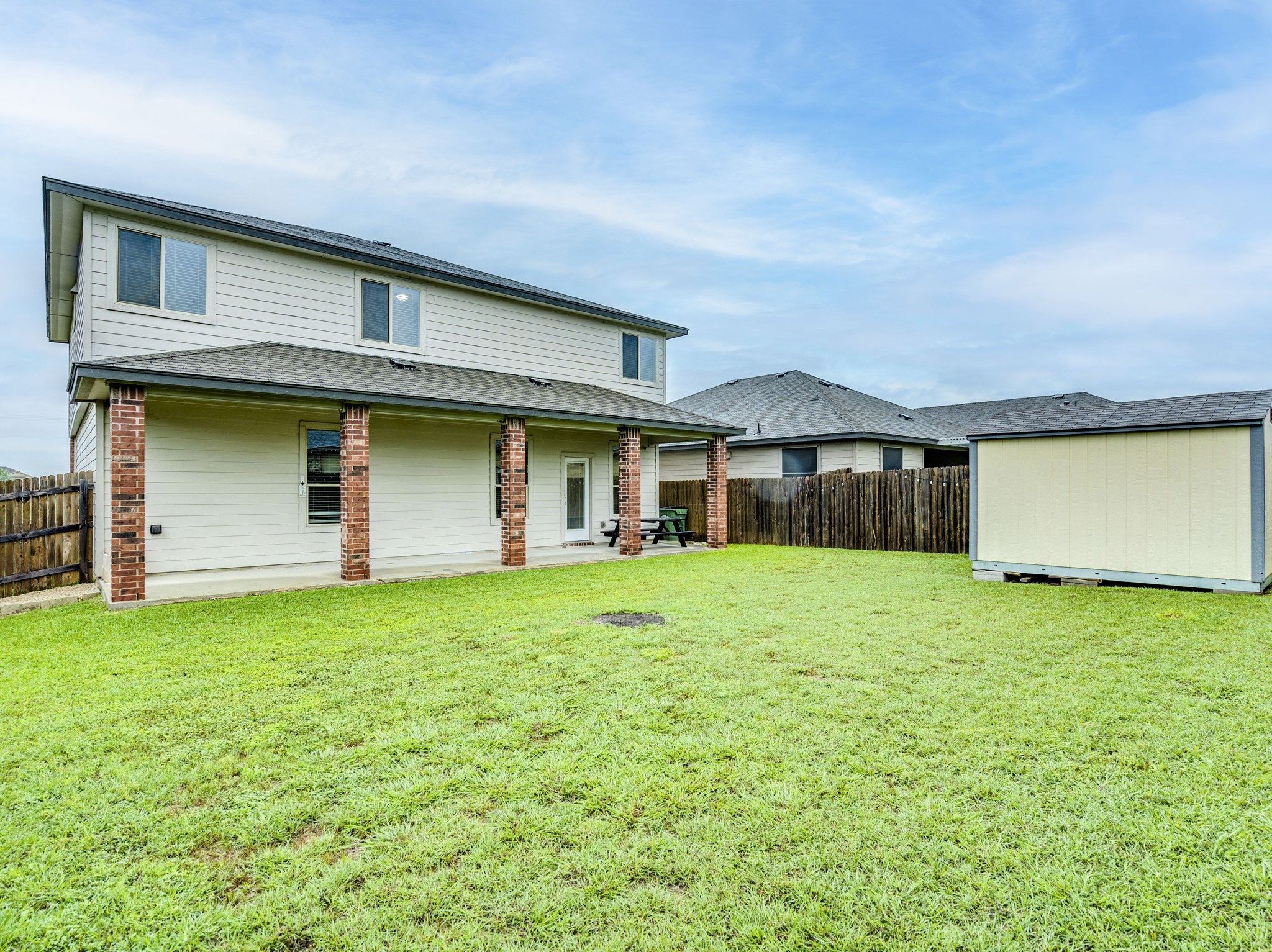 213 Ammonite Lane Jarrell, TX 76537 - Photo 32 of 34 a front view of a house with a garden