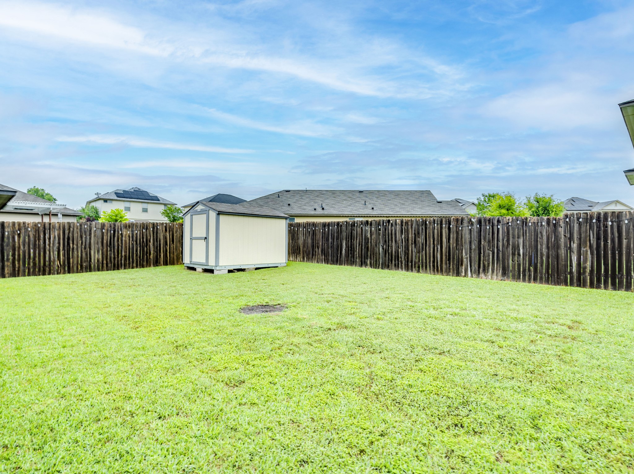 213 Ammonite Lane Jarrell, TX 76537 - Photo 33 of 34 a view of a backyard with wooden fence