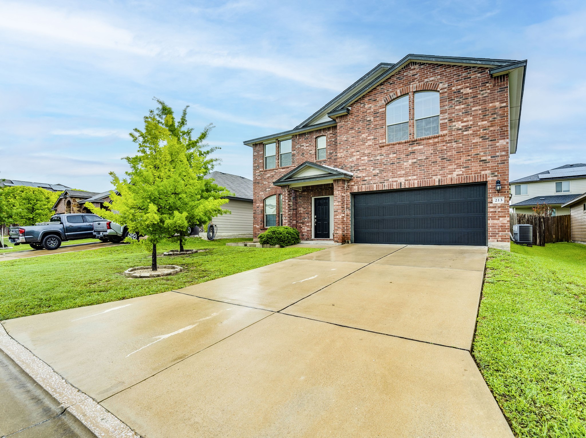 213 Ammonite Lane Jarrell, TX 76537 - Photo 5 of 34 a front view of a house with a yard and garage