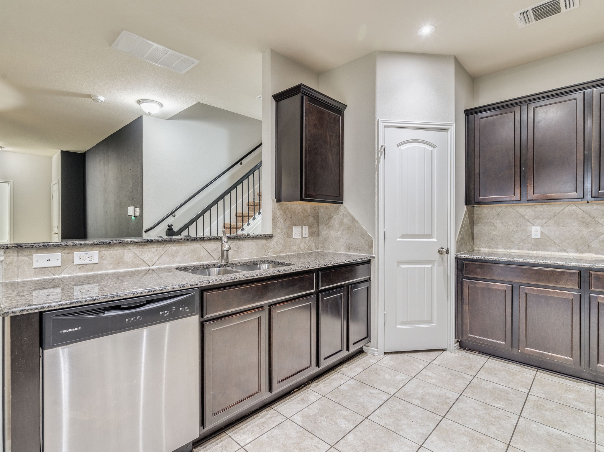 213 Ammonite Lane Jarrell, TX 76537 - Photo 7 of 34 a kitchen with stainless steel appliances granite countertop a sink and a refrigerator