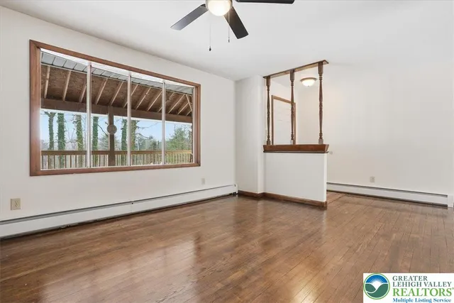 a view of kitchen with stainless steel appliances granite countertop a stove top oven a sink with wooden floor and cabinets
