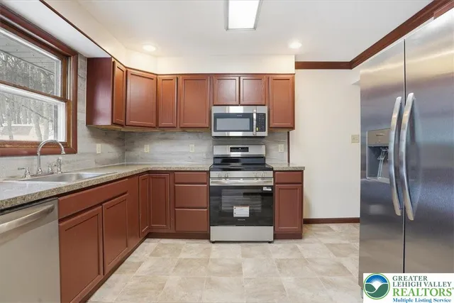 a kitchen with granite countertop stainless steel appliances and a counter top space