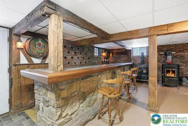 a view of swimming pool with outdoor seating and trees in the background