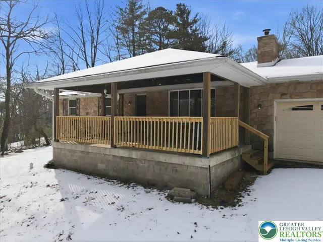 an empty room with windows and fireplace