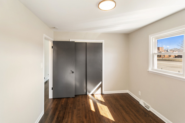 2912 175th Street Hazel Crest, IL 60429 - Photo 7 of 13 a view of an empty room with wooden floor and a window