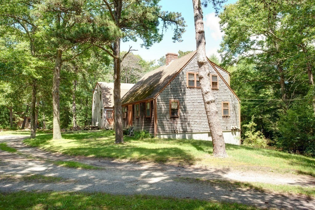 262 County Road Bourne, MA 02532 - Photo 6 of 23 a view of a white house next to a yard with big trees