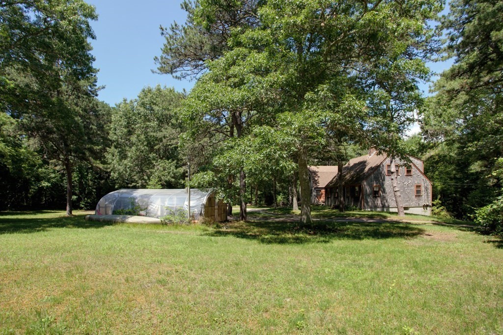262 County Road Bourne, MA 02532 - Photo 10 of 23 a front view of a house with a yard and trees
