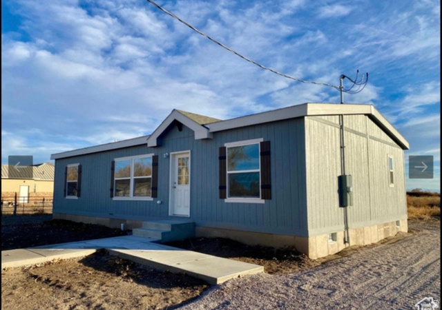 289 West Center Street Hinckley, UT 84635 - Photo 1 of 13 Single-story residential structure featuring light blue vertical siding and a white trim