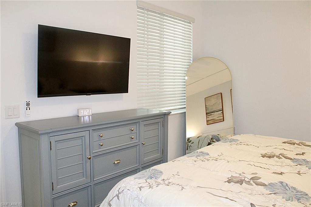 15405 Grn Acrs Avenue, Unit 2341 Babcock Ranch, FL 33982 - Photo 12 of 28 a bedroom with a bed and a flat screen tv