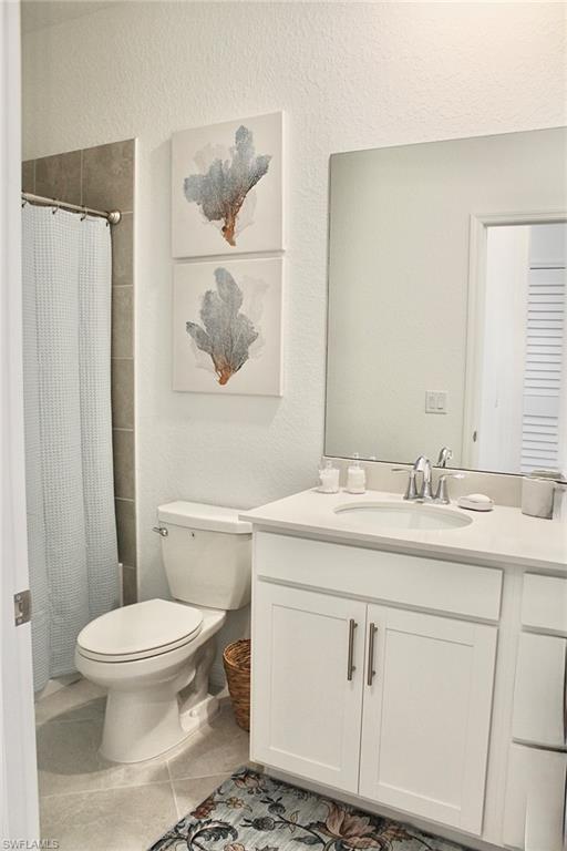 15405 Grn Acrs Avenue, Unit 2341 Babcock Ranch, FL 33982 - Photo 16 of 28 a bathroom with a granite countertop toilet sink and mirror