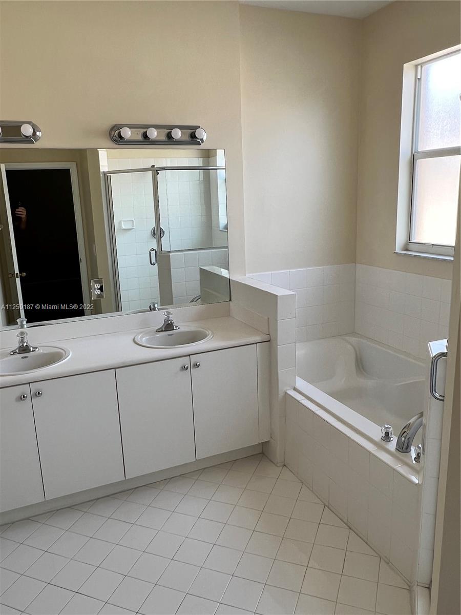 Three Lakes Miami, FL 33186 - Photo 21 of 23 a bathroom with a granite countertop sink a mirror and bathtub