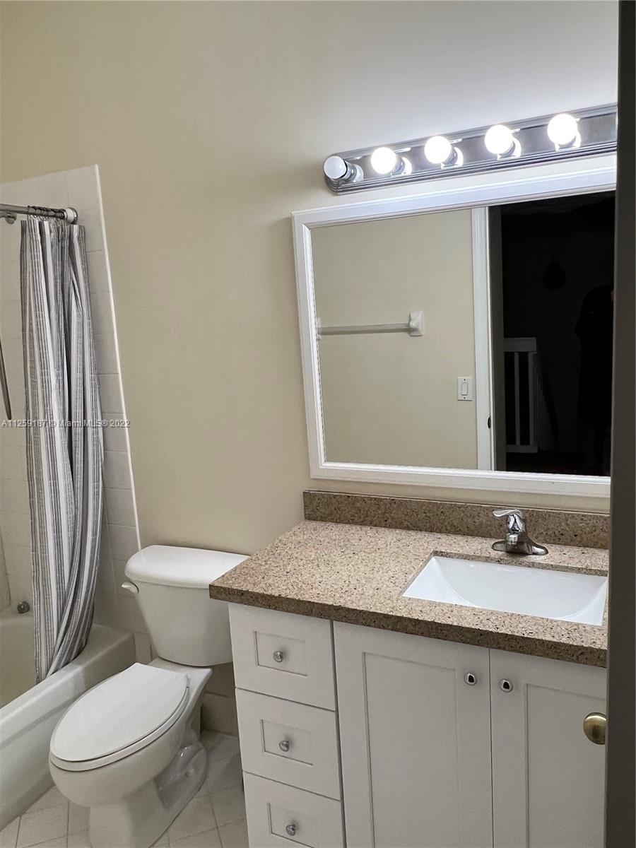 Three Lakes Miami, FL 33186 - Photo 23 of 23 a bathroom with a granite countertop toilet sink and mirror